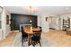 Dining room featuring accent wall, modern chandelier, and great natural light at 7242 Highburry Dr, Indianapolis, IN 46256