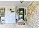 Welcoming front door with stone accents and cozy outdoor seating for relaxing at 7242 Highburry Dr, Indianapolis, IN 46256