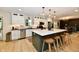 Bright kitchen featuring a large island with bar seating, stainless steel appliances, and wood floors at 7242 Highburry Dr, Indianapolis, IN 46256