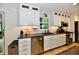 Bright kitchen with stainless steel appliances, black countertops, and modern white cabinetry at 7242 Highburry Dr, Indianapolis, IN 46256