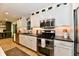 Updated kitchen with stainless steel appliances, sleek countertops, and modern white cabinetry at 7242 Highburry Dr, Indianapolis, IN 46256