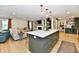 Open-concept kitchen with a large island that connects to a comfortable living area at 7242 Highburry Dr, Indianapolis, IN 46256
