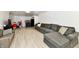Finished basement living room features light floors, a large gray sectional sofa, and an entertainment area at 7242 Highburry Dr, Indianapolis, IN 46256