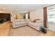 Bright living room features a neutral sectional sofa, hardwood floors, and a large rug at 7242 Highburry Dr, Indianapolis, IN 46256