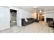 Spacious living room with a comfortable gray sectional sofa and open doorway to the finished basement bathroom at 7242 Highburry Dr, Indianapolis, IN 46256