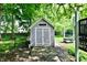 Outdoor shed with double doors and a charming design, perfect for storage in a well-maintained backyard at 7242 Highburry Dr, Indianapolis, IN 46256