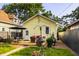 Landscaped backyard featuring a wooden deck with dining set, mature trees, and well-maintained lawn at 743 Sanders St, Indianapolis, IN 46203