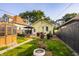 The backyard featuring a greenhouse and raised garden beds surrounded by grass and a fence creates a serene and green outdoor space at 743 Sanders St, Indianapolis, IN 46203