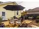 Backyard featuring a wooden deck with patio furniture, an umbrella, and colorful landscaping of flowers and green bushes at 743 Sanders St, Indianapolis, IN 46203