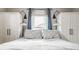 Bedroom featuring a large window flanked by custom storage cabinets and stylish sconce lighting at 743 Sanders St, Indianapolis, IN 46203