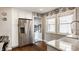 Kitchen with stainless steel refrigerator, farmhouse sink, and view to the lower level at 743 Sanders St, Indianapolis, IN 46203