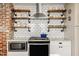 Kitchen features open shelving, stainless appliances, white cabinets, and tile backsplash at 743 Sanders St, Indianapolis, IN 46203