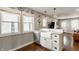 Kitchen with farmhouse sink, granite countertops, stainless steel appliances, and view to living area at 743 Sanders St, Indianapolis, IN 46203