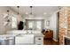 Bright open kitchen with granite countertops, a farmhouse sink, stainless appliances, and a brick wall at 743 Sanders St, Indianapolis, IN 46203