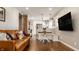 Open-concept living room showcasing a leather sofa and seamless connection to the modern kitchen at 743 Sanders St, Indianapolis, IN 46203