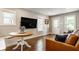 Well-lit living room featuring hardwood floors, modern decor, and access to the home's entrance at 743 Sanders St, Indianapolis, IN 46203