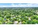 Expansive aerial view capturing the lush greenery of a neighborhood with many mature trees, single Gathering homes at 7504 Troon Ct, Indianapolis, IN 46237