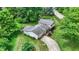 Aerial perspective of a vinyl sided home with an attached garage in a well-kept neighborhood with mature trees at 7504 Troon Ct, Indianapolis, IN 46237