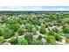 Overhead image capturing a verdant residential area with tree-lined streets and neatly arranged houses in a quiet, established neighborhood at 7504 Troon Ct, Indianapolis, IN 46237