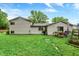 Backyard features green grass with the back side of a house at 7504 Troon Ct, Indianapolis, IN 46237