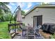 Backyard patio with 4 chairs, small garden box, and patio umbrella at 7504 Troon Ct, Indianapolis, IN 46237