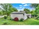 A home's vinyl sided exterior, fenced yard and landscaped backyard create an ideal outdoor living space at 7504 Troon Ct, Indianapolis, IN 46237