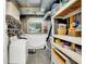 Basement laundry area with washer, shelving and large storage space at 7504 Troon Ct, Indianapolis, IN 46237