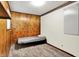 Bedroom features paneled walls, neutral carpet, and natural light from the window at 7504 Troon Ct, Indianapolis, IN 46237