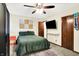 Bedroom with ceiling fan, large bed, statement wall art and wardrobe at 7504 Troon Ct, Indianapolis, IN 46237