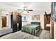 Bedroom with ceiling fan, large bed, statement wall art and wardrobe at 7504 Troon Ct, Indianapolis, IN 46237