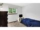 Small bedroom features a television and window with green foliage outside at 7504 Troon Ct, Indianapolis, IN 46237