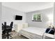 Bright bedroom featuring a desk and white dresser under a mounted television at 7504 Troon Ct, Indianapolis, IN 46237