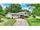 Charming two-story home featuring vinyl siding, brick accents, a two-car garage, and a beautifully landscaped yard at 7504 Troon Ct, Indianapolis, IN 46237