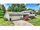 This well-maintained two-story home features vinyl siding, brick accents, and a spacious two-car attached garage at 7504 Troon Ct, Indianapolis, IN 46237