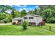 Well-maintained two-story home featuring vinyl siding, brick accents, tasteful landscaping, and a partially fenced yard at 7504 Troon Ct, Indianapolis, IN 46237