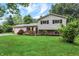 Inviting two-story home featuring a lush green lawn, brick accents, and an attached two-car garage at 7504 Troon Ct, Indianapolis, IN 46237