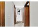 Hallway with wooden doorframes leading to stairs and kitchen area at 7504 Troon Ct, Indianapolis, IN 46237