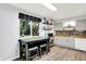 Bright kitchen with natural light from a large window, decorative backsplash, and modern flooring at 7504 Troon Ct, Indianapolis, IN 46237