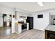 Bright kitchen features gray cabinets, wood floors and black appliances at 7504 Troon Ct, Indianapolis, IN 46237