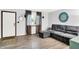 Comfortable living area with a plush sectional sofa, wood-look flooring, and a bright window at 7504 Troon Ct, Indianapolis, IN 46237