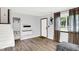 Bright living room features light wood floors, fresh grey paint, and a large window for natural light at 7504 Troon Ct, Indianapolis, IN 46237