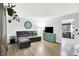 Spacious living room with wood-look flooring, a modern sofa, and stylish decor at 7504 Troon Ct, Indianapolis, IN 46237