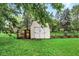Storage shed with a small chicken coop and garden boxes at 7504 Troon Ct, Indianapolis, IN 46237