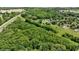 Lush wooded property view showcases beautiful surrounding landscape and neighborhood amenities at 7811 N County Road 500 E, Pittsboro, IN 46167