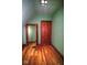 Finished attic shows wood floors, classic trim, and an original wood door at 783 Woodruff Place Middle Dr, Indianapolis, IN 46201