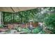 Lush backyard featuring a wooden deck with a dining set and a hot tub, creating a perfect outdoor living space at 783 Woodruff Place Middle Dr, Indianapolis, IN 46201