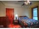 Cozy bedroom with wood floors, trim, ceiling fan and a floral print bedspread at 783 Woodruff Place Middle Dr, Indianapolis, IN 46201