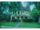 Charming two-story home with a well-manicured lawn and inviting front porch at 783 Woodruff Place Middle Dr, Indianapolis, IN 46201