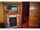 Elaborate fireplace with an ornate mirror and decorative tiles near an open doorway at 783 Woodruff Place Middle Dr, Indianapolis, IN 46201