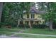 Charming two-story home with well-manicured landscaping and inviting front porch at 783 Woodruff Place Middle Dr, Indianapolis, IN 46201